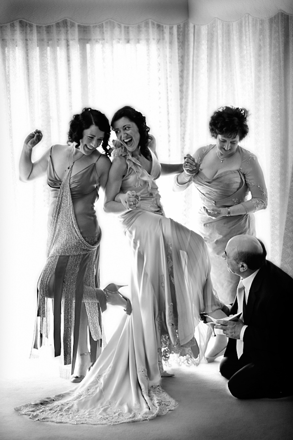 Bride in vintage dress having fun getting ready - wedding photo by Jerry Ghionis